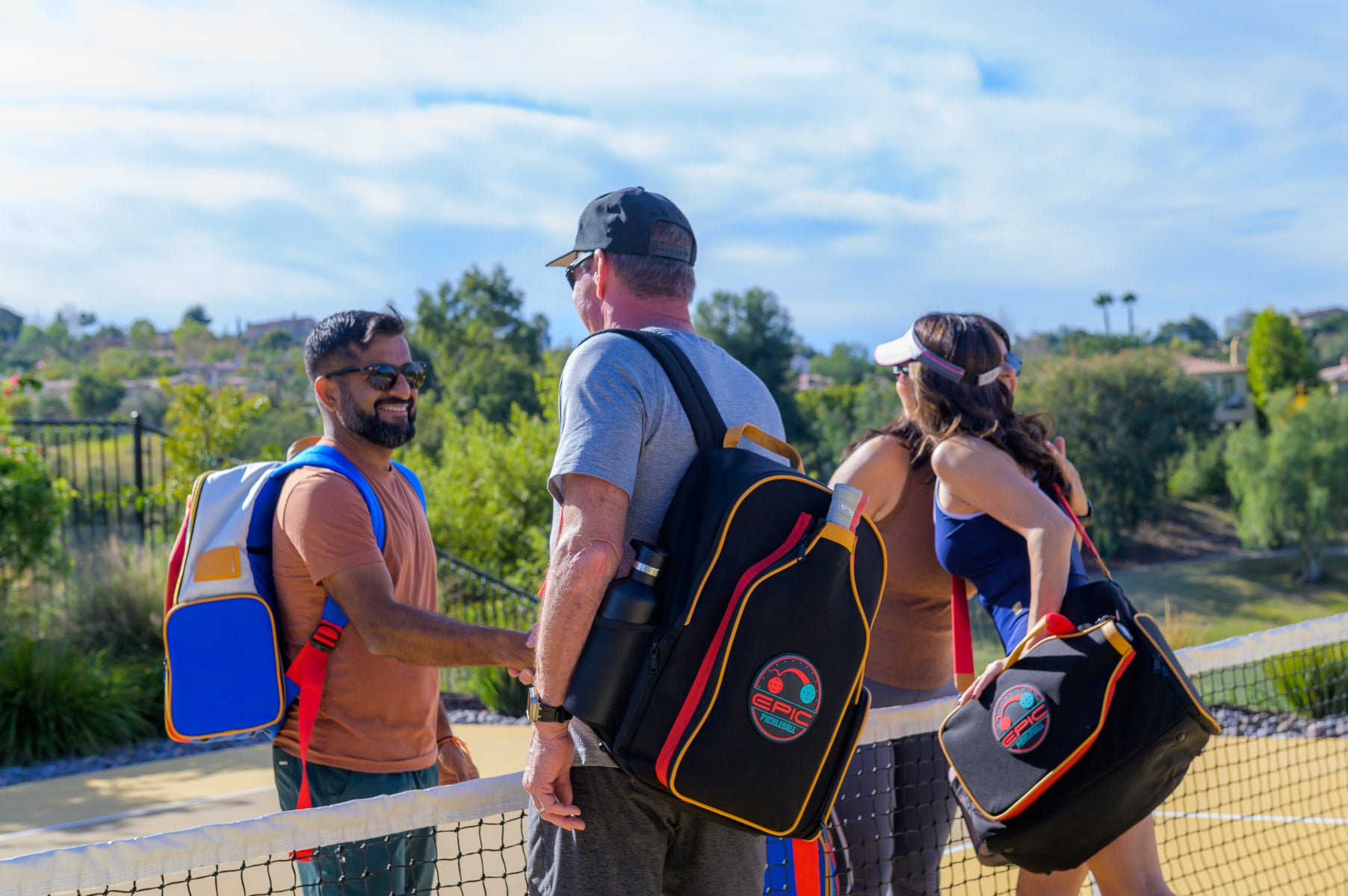 group of pickleball players with stylish pickleball bags chatting before a match